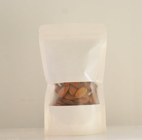 Bolsa de papel blanca con almendras ecológicas