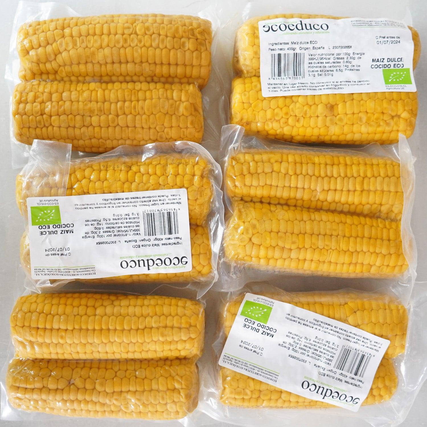 Varios paquetes de dos mazorcas de maíz cocidas y envasadas al vacío